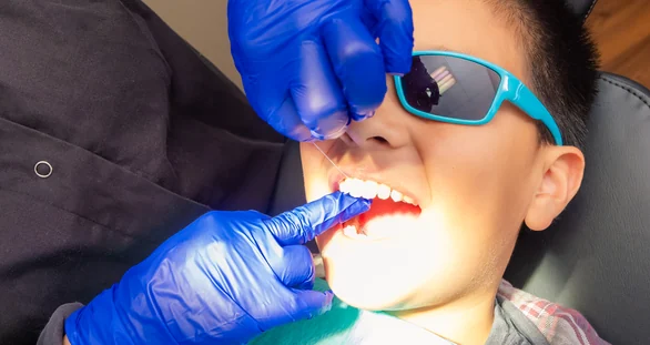 Gentle flossing during a preventive visit at Pleasant Valley Pediatric Dentistry