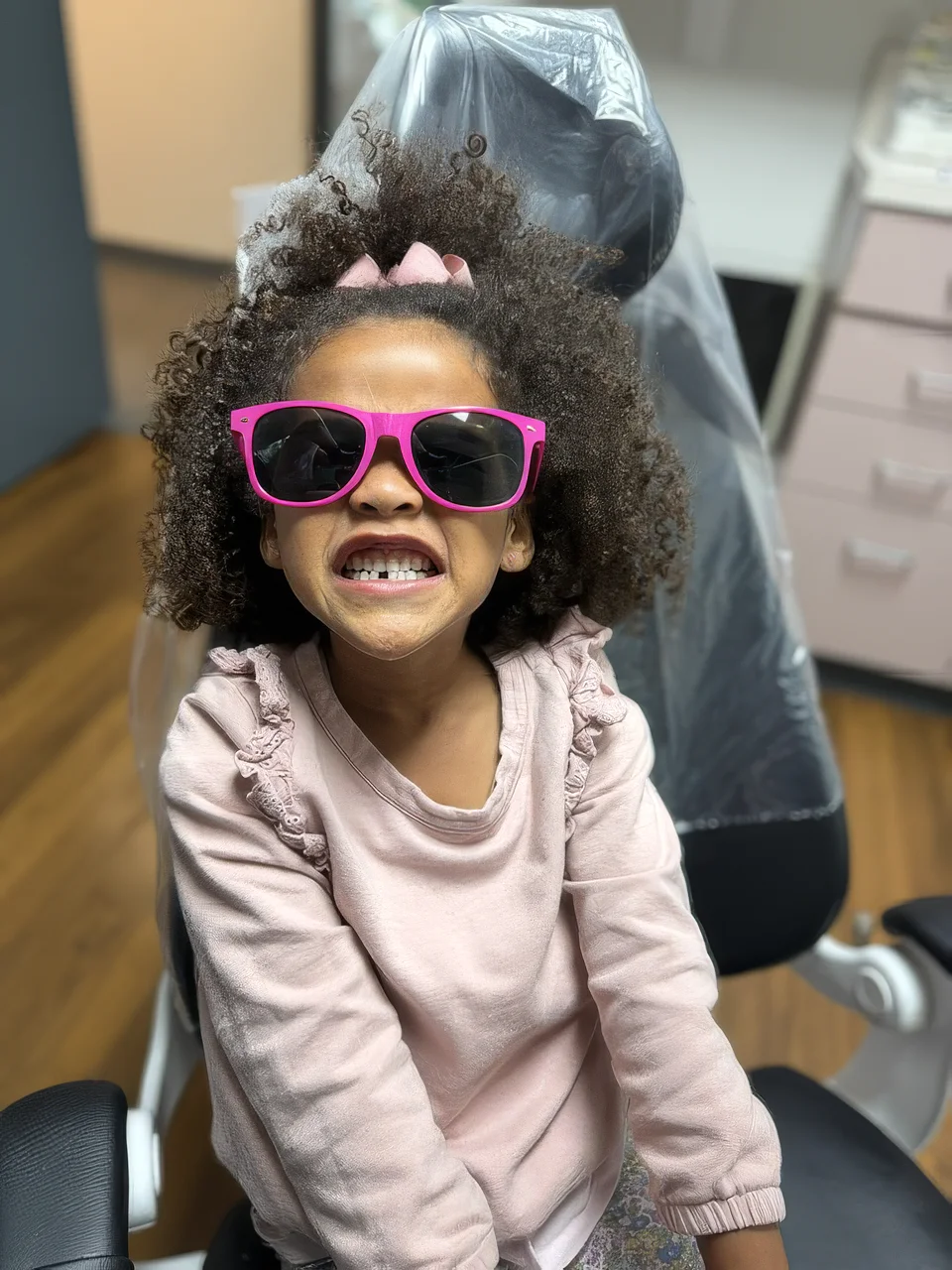 Young patient smiling in the dental chair during a routine visit