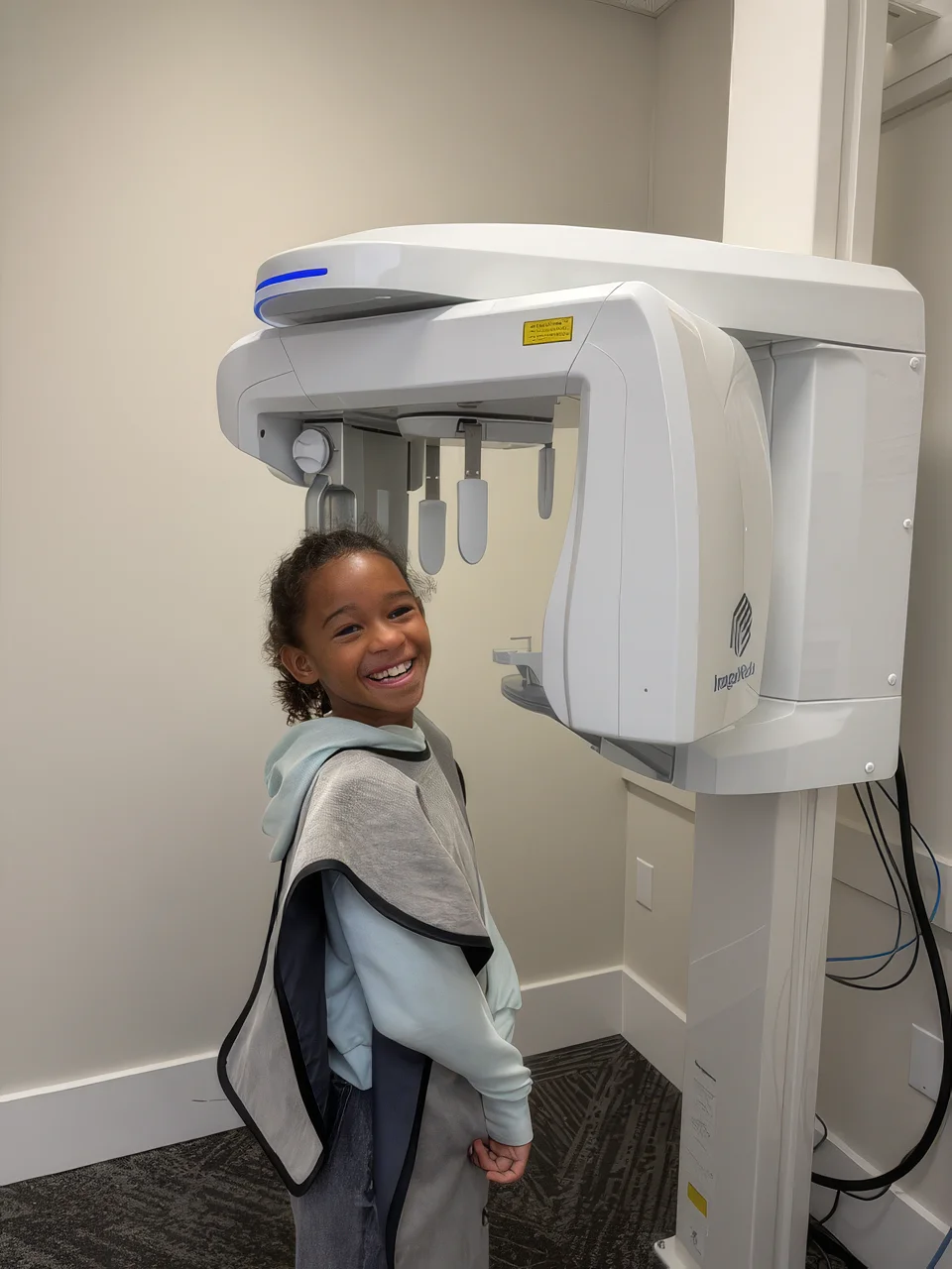 Young patient next to the panoramic X-ray unit