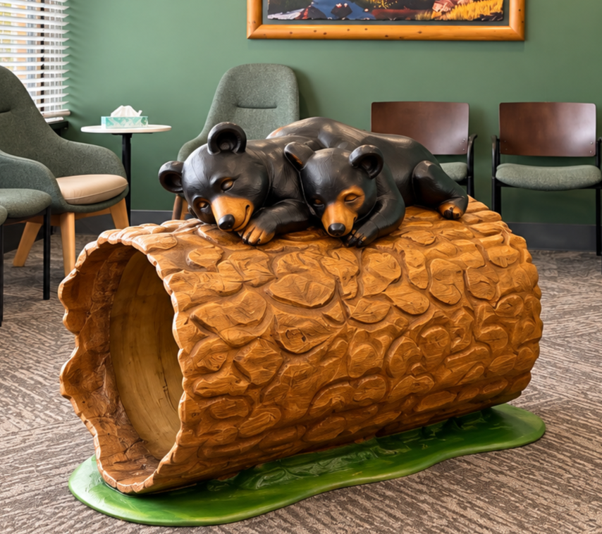 Baby bears Berry and Hubert playing on a log in the office